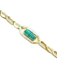 Gold bracelet with a baguette cut natural emerald, a unique design with accent natural diamonds, crafted in 14k yellow gold.