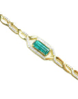 Gold bracelet with a baguette cut natural emerald, a unique design with accent natural diamonds, crafted in 14k yellow gold.