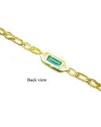 Back view of a 14K yellow gold bracelet with a rectangular emerald-cut green emerald.