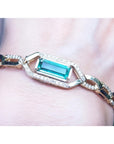 Gold bracelet with a rectangular natural colombian emerald emerald-cut vibrant bluish medium green hue.