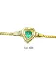 Back of a 14K yellow gold bracelet with a heart-shaped emerald.