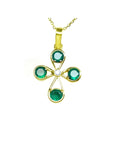 A natural four stone emerald cross pendant in yellow gold topside view.