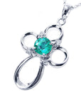 A 14k white gold emerald pendant necklace showing the topside profile view.