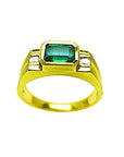 A bezel set men's emerald ring with side accent diamonds in yellow gold topside view.