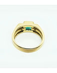 Men's 14K yellow gold ring with a bezel-set natural emerald and side diamonds.