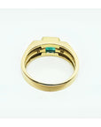 Men's 14K yellow gold ring with a bezel-set natural emerald and side diamonds.