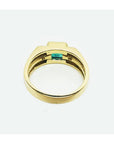 Men's 14K yellow gold ring with a bezel-set natural emerald and side diamonds.