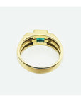 Men's 14K yellow gold ring with a bezel-set natural emerald and side diamonds.
