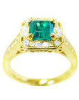 Top side view of a 14k yellow gold emerald and diamond ring.