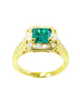 Top side view of a 14k yellow gold emerald and diamond ring.