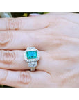 2.47 ct GIA certified F1 emerald engagement ring with diamond halo and baguette side diamonds in 18K white gold.