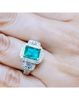 2.47 ct. GIA certified F1 emerald engagement ring in 18K white gold with diamond halo and baguette side diamonds.