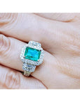 2.47 ct. GIA certified F1 emerald engagement ring in 18K white gold with diamond halo and baguette side diamonds.