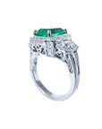 This is a halo diamond and natural emerald engagement ring on a top and downside profile display.