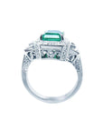 A 18k white gold natural emerald ring on a lateral position with top and gallery view.