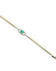 14K yellow gold bracelet with a square emerald-cut Colombian emerald in a diamond-accented setting.