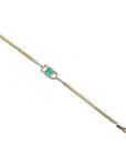 14K yellow gold bracelet with a square emerald-cut Colombian emerald in a diamond-accented setting.