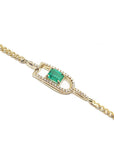 Gold bracelet with a square natural emerald on a side profile view.
