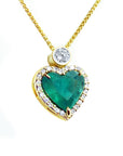 Heart-shaped pendant with a natural emerald and gold chain on topside view position.