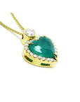 18k gold heart pendant with a bluish-green emerald haloed by diamonds on a delicate chain.