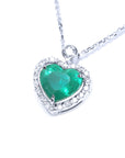 Heart-shaped emerald pendant with diamond accents on a topside left profile position.