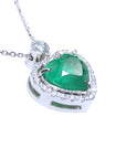 Heart-shaped emerald pendant with diamond accents on a toside anda gallery profile view.