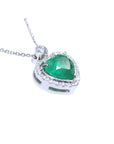 Heart-shaped emerald pendant with diamond accents on a toside anda gallery profile view.
