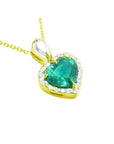 Heart-shaped emerald pendant with gold frame and halo of natural diamond accents.