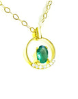 Oval cut natural colombian emerald in 14k yellow gold necklace with diamonds.