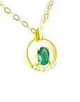 Oval cut natural colombian emerald in 14k yellow gold necklace with diamonds.