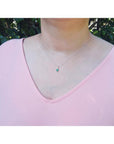 0.27 ct emerald pendant necklace in 14K white gold, worn on a model.