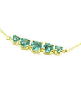 14K gold necklace with five round, medium light green Colombian emeralds, graduated in size.