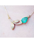 14K yellow gold twig necklace with a pear-cut natural emerald and diamond accents.