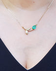 May's birthstone Colombian Emerald necklace sourced from Muzo mines; nature inspired design handcrafted in 14k yellow gold