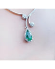 Pear cut 2.26ct natural emerald necklace in 18K white gold with diamond halo and accents.