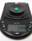 Natural colombian emerald pear cut on a digital scale showing it wight