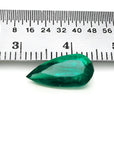2.25 ct natural pear-cut Muzo Mine Colombian emerald, vivid bluish-green, next to a ruler.