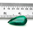 2.25 ct natural pear-cut Muzo Mine Colombian emerald, vivid bluish-green, next to a ruler.