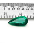 2.25 ct natural pear-cut Muzo Mine Colombian emerald, vivid bluish-green, next to a ruler.