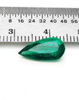 2.25 ct natural pear-cut Muzo Mine Colombian emerald, vivid bluish-green, next to a ruler.