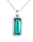 Emerald pendant necklace with a halo diamond on a white background