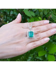 7.78 ct. natural emerald pendant with halo diamonds in 14K white gold, antique-inspired design.