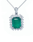 A Muzo mine emerald pendant necklace with a halo diamond on a white gold chain topside view