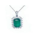 A Muzo mine emerald pendant necklace with a halo diamond on a white gold chain topside view