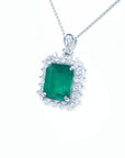 Emerald green gemstone pendant with diamonds accent on a white gold chain