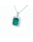 Emerald green gemstone pendant with diamonds accent on a white gold chain