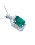 7.78 ct. deep green rectangular emerald pendant with double halo diamonds on a 14K white gold chain.