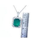 7.78 ct. rectangular natural emerald pendant with double halo diamonds in 14K white gold, shown with ruler.
