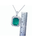 7.78 ct. rectangular natural emerald pendant with double halo diamonds in 14K white gold, shown with ruler.