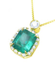 Topside profile of a colombian square emerald into a halo diamond handcrafted in 18k yellow gold.